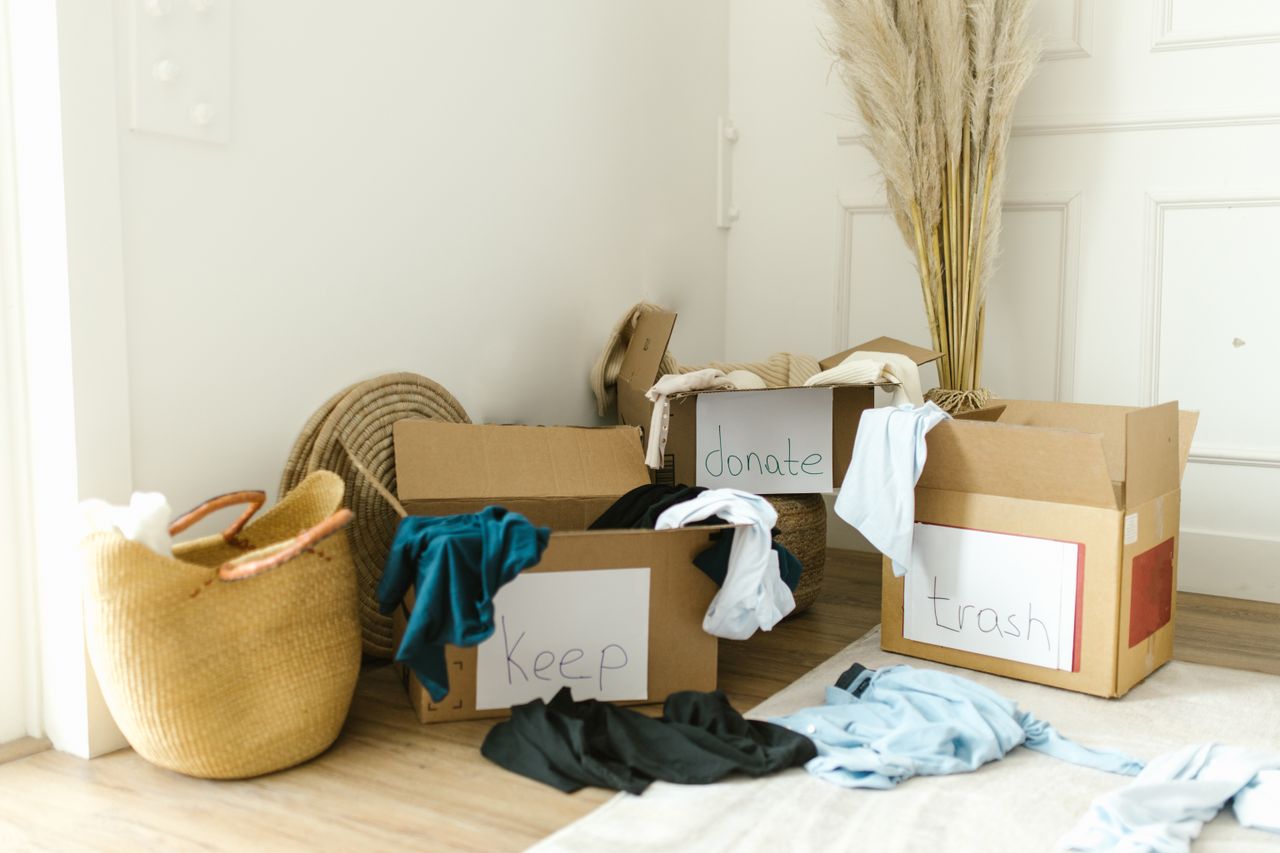 journey Cardboard boxes labeled Keep, Donate, and Trash for home decluttering.